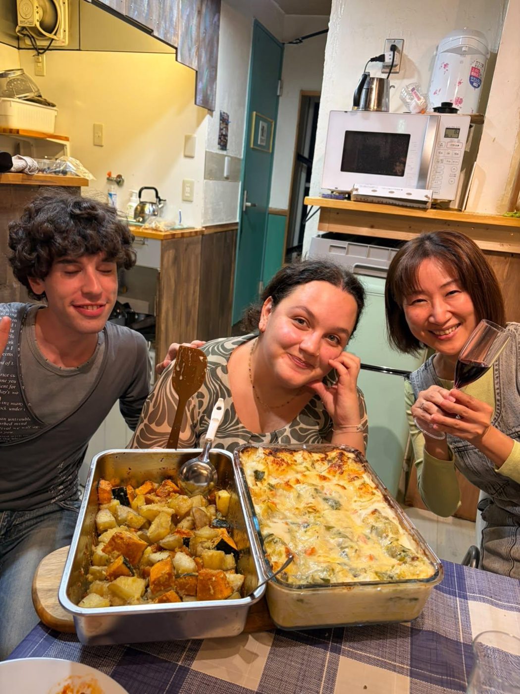 Residents and guests with a gratin they baked together